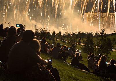 Silhouette people watching firework display during new year celebration