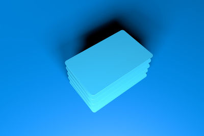 High angle view of cards against blue background