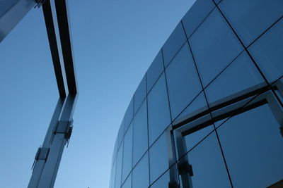 Low angle view of modern building against clear blue sky