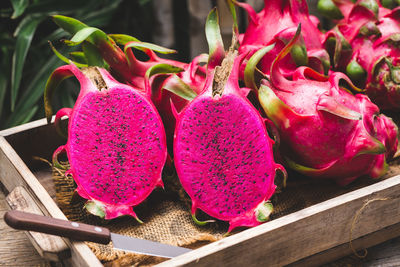 Close-up of pink fruits on table at market stall