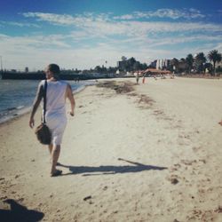 Full length of woman standing on beach