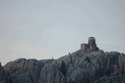 Low angle view of castle on mountain against sky