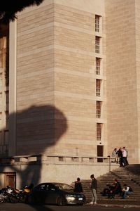 People standing on road in city