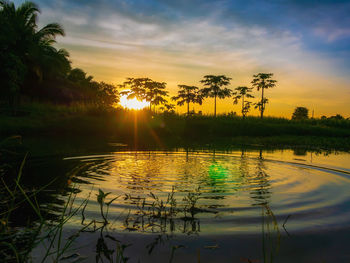 Scenic view of lake against sky during sunset