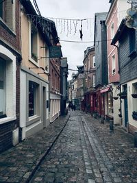 Empty alley amidst buildings in city