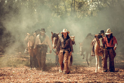 Panoramic shot of people riding horses