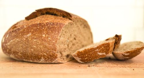 Close-up of bread on table against white background