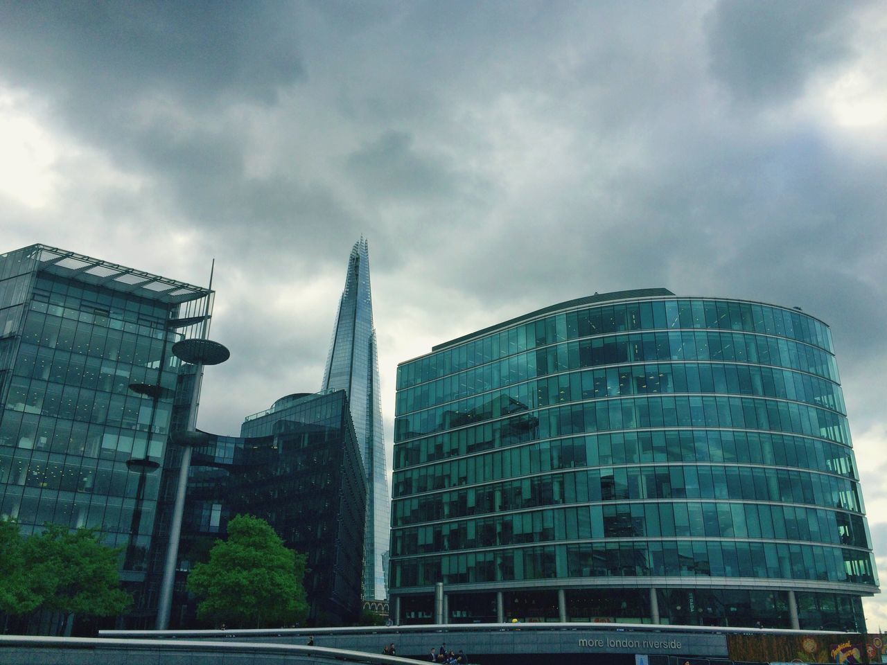 architecture, building exterior, built structure, sky, low angle view, city, modern, cloud - sky, office building, glass - material, cloudy, building, tall - high, skyscraper, tower, cloud, window, reflection, day, outdoors