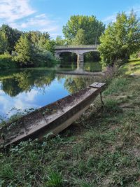 Arch bridge over river against sky