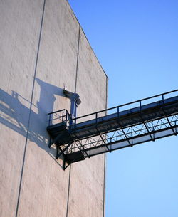 Low angle view of crane against clear sky