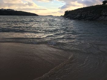 Scenic view of beach against sky during sunset