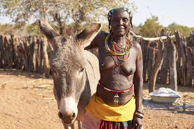 Traditional mudimba tribe woman and her donkey, canhimei, angola