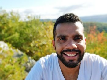 Portrait of smiling man against sky