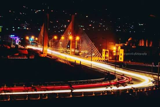 TRAFFIC LIGHT TRAILS ON ROAD AT NIGHT