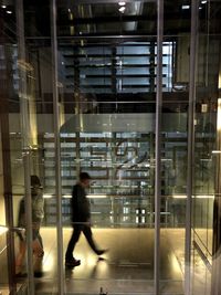 Side view of a man walking in modern building