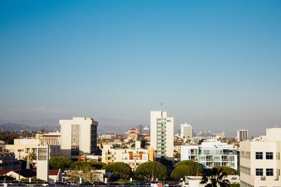 Cityscape against clear blue sky