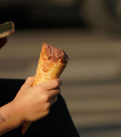 Close-up of hand holding ice cream