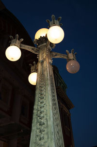 Low angle view of illuminated building against sky