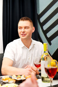 Portrait of young man with drink