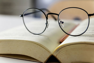 Close-up of eyeglasses on book