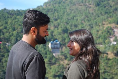 Side view of a smiling young couple