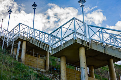 Low angle view of bridge against buildings