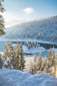 Scenic view of frozen lake against sky during winter