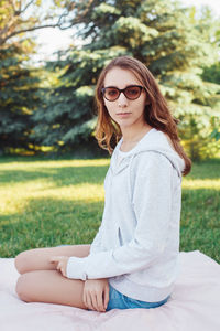 Portrait of young woman sitting outdoors