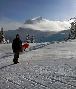 Full length of man on snowcapped mountain against sky