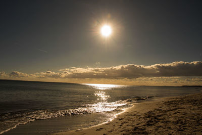 Scenic view of beach against sky during sunset