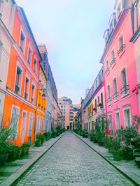 Street amidst buildings in city against sky