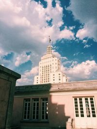 Low angle view of building against cloudy sky