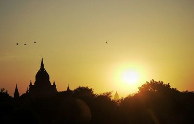 Silhouette of building against sky during sunset