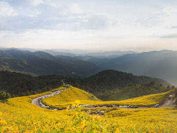 Scenic view of landscape and mountains against sky