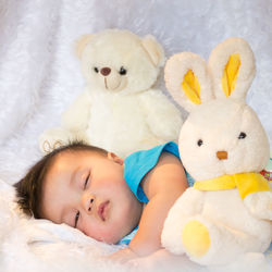 High angle view of cute baby boy sleeping on fur sheet at home