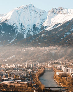 Aerial view of city by snowcapped mountains