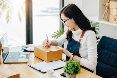 Young woman using laptop at home