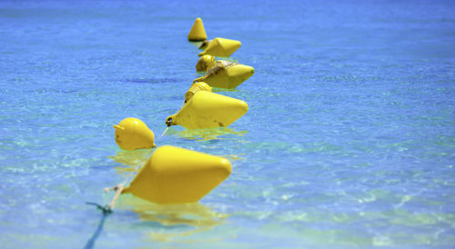 Yellow floats at calm blue sea