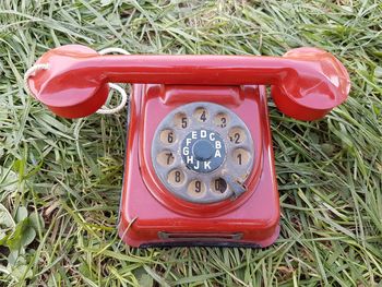 High angle view of old telephone booth on grass