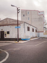 Street by road against buildings in city