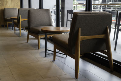 Empty chairs and table in building