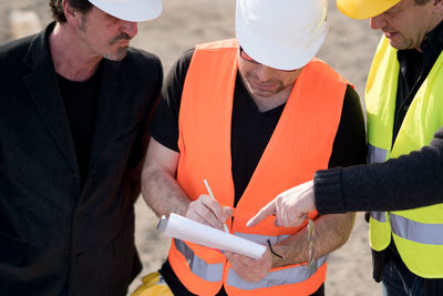 Coworkers working at construction site