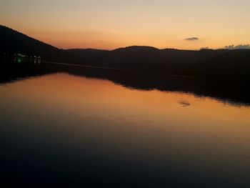 Scenic view of lake against romantic sky at sunset