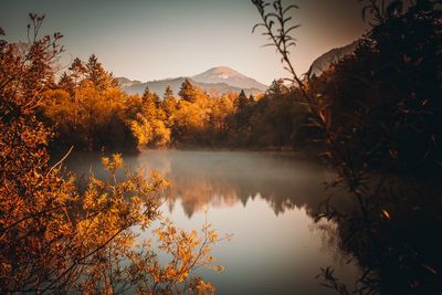 Scenic view of lake by trees against sky during autumn