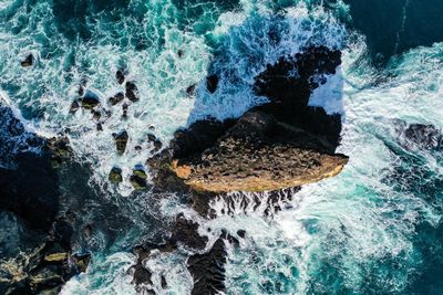 High angle view of rock formation in sea