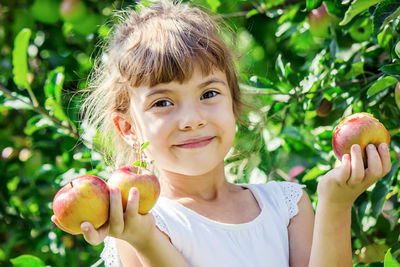Portrait of girl holding apple