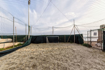 View of soccer field against cloudy sky