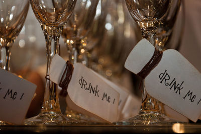 Close-up of label hanging in wineglass