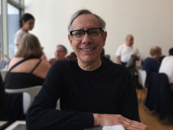 Portrait of senior man sitting at table in restaurant