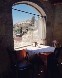 View of restaurant and buildings seen through window